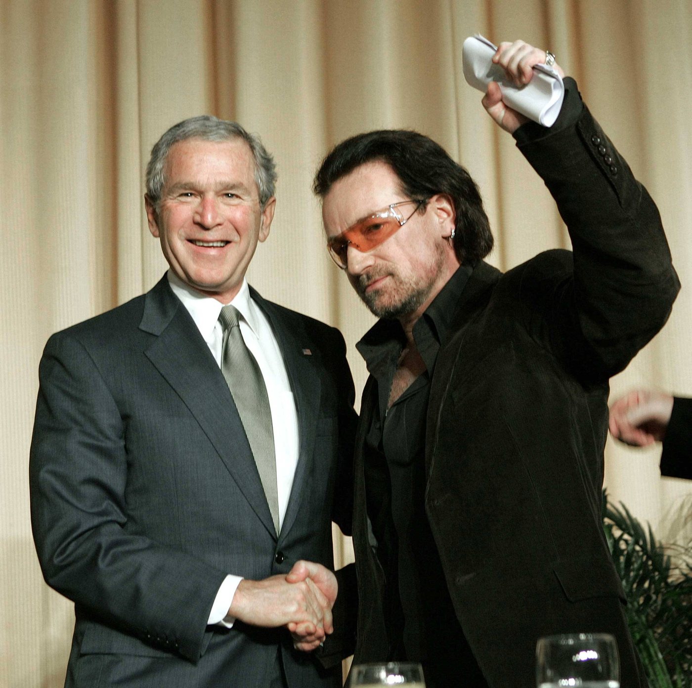 President George W. Bush shaking hands with Bono at the Prayer Breakfast