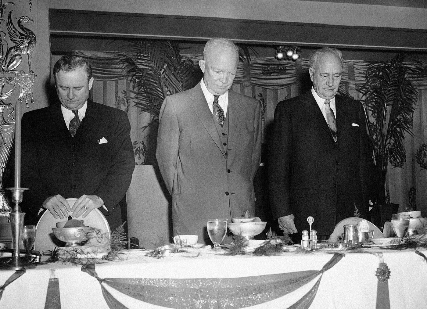 President Dwight D. Eisenhower with head bowed in prayer at the Prayer Breakfast